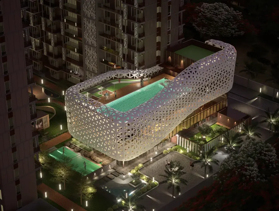 Eldeco clubhouse at night with a perforated white lattice facade wrapping a rooftop swimming pool (artist's impression)