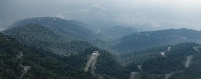 Real drone photograph of misty forested ridges near Narendra Nagar
