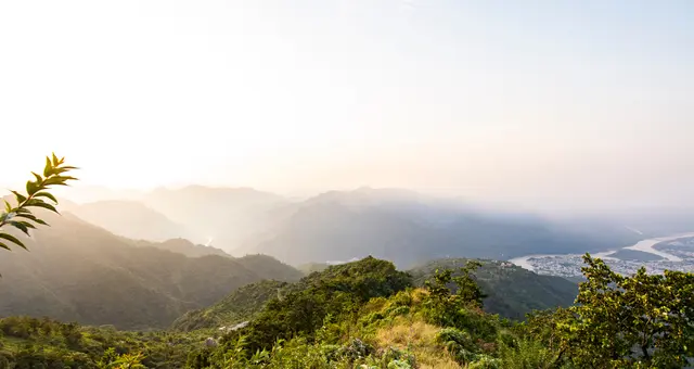 Real photograph: sunrise over forested ridges and the river valley near Rishikesh
